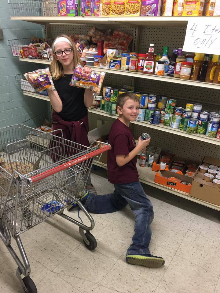 Young volunteers stocking shelves